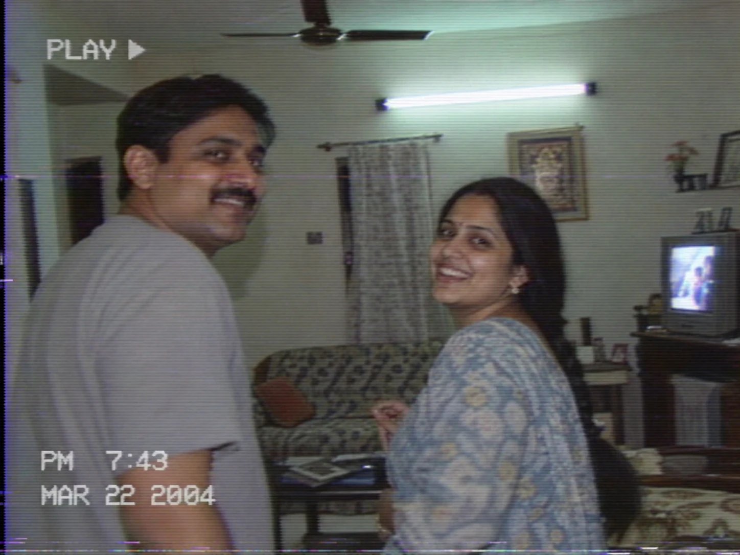 Couple captured as a grainy VHS camcorder freeze frame with scan lines