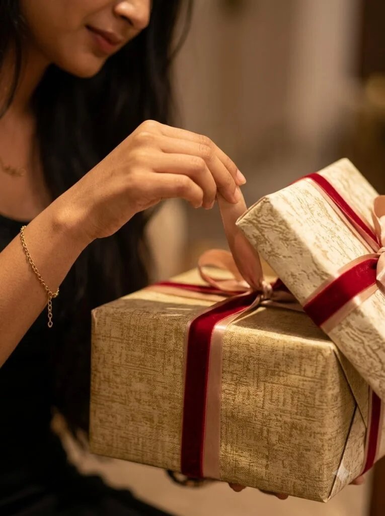 Girl opening a ribboned birthday gift box