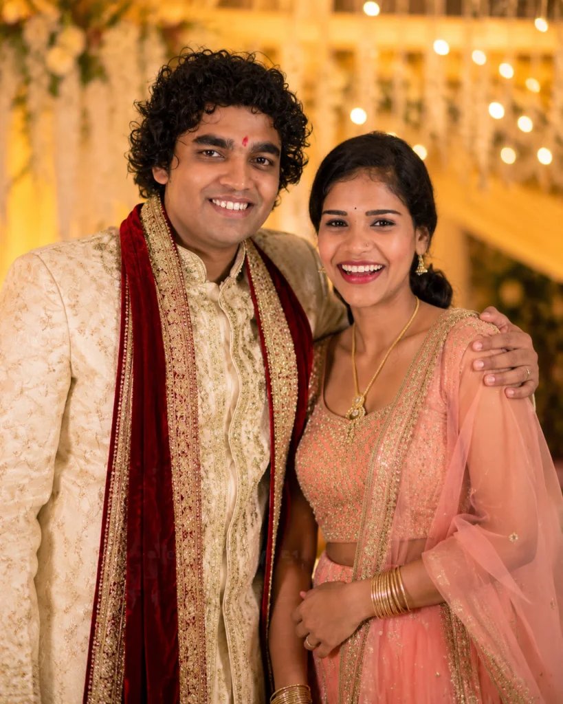 Adult siblings posing together in traditional clothing at a wedding
