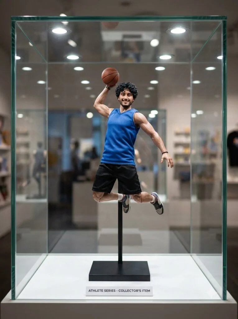 Athletic figurine displayed inside a glass display case with soft interior lighting
