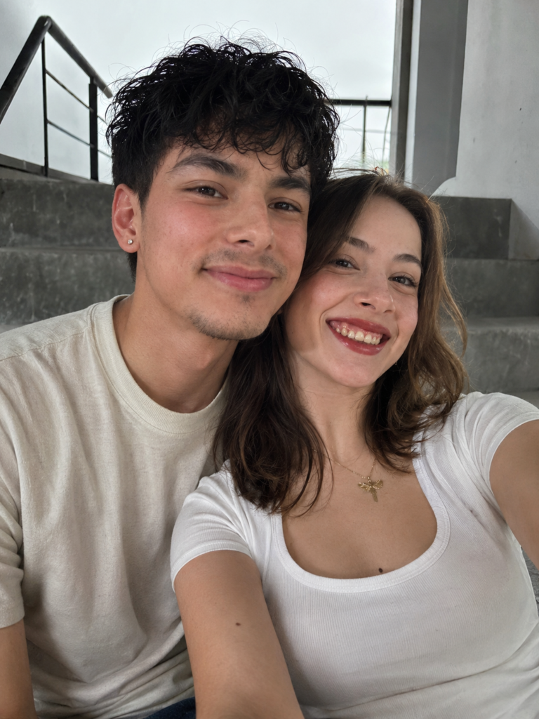 Ultra-realistic couple portrait on apartment steps with natural skin texture and overcast light