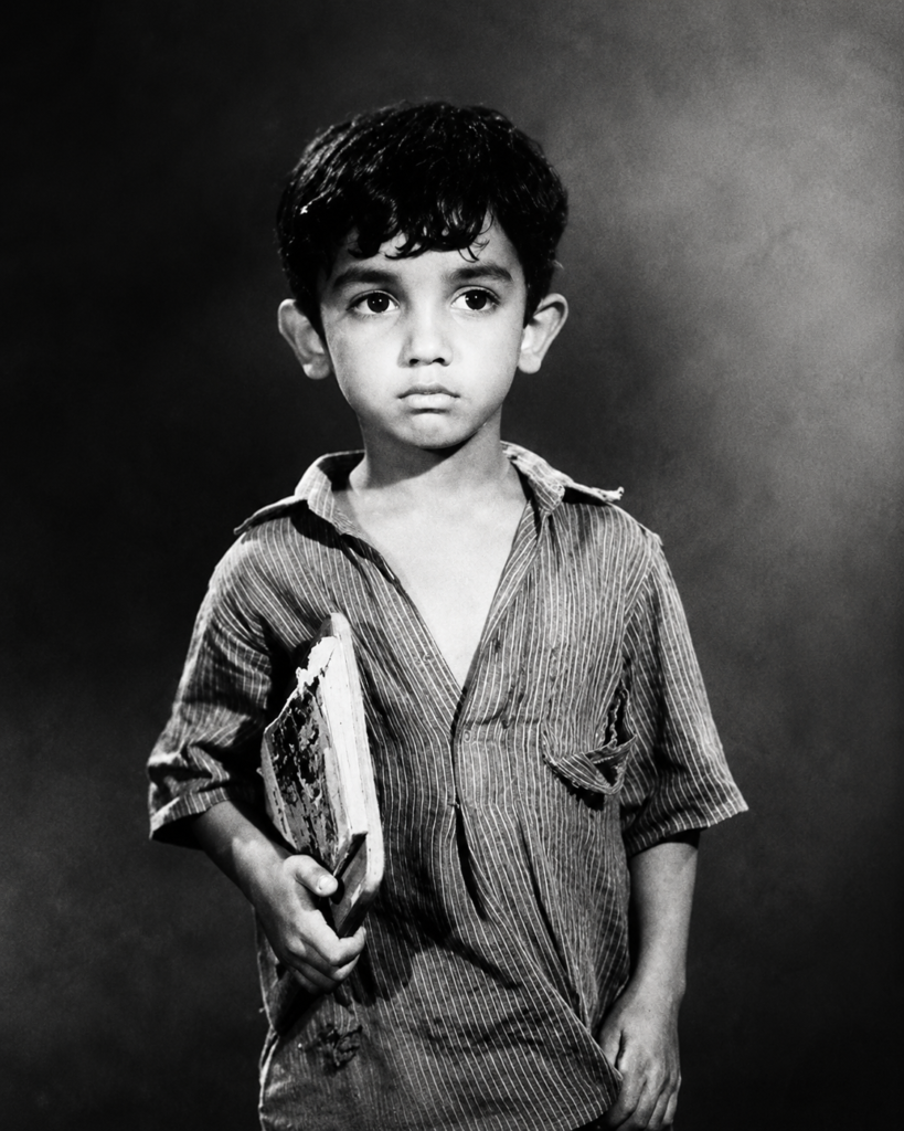 Fine-art black and white childhood portrait with soft directional light