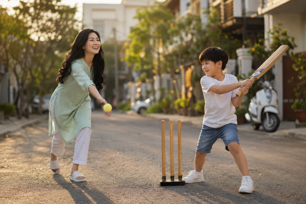 Mother and young son playing cricket together in a residential street