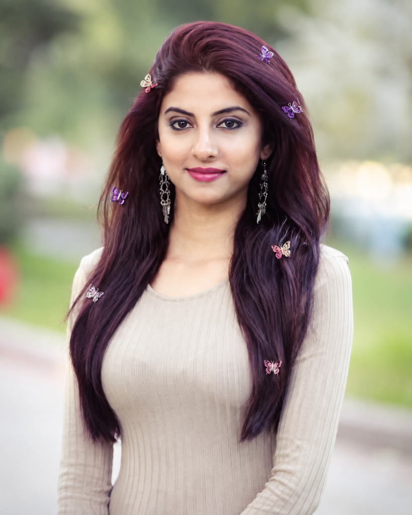 Woman wearing delicate butterfly hair clips scattered through her long hairstyle