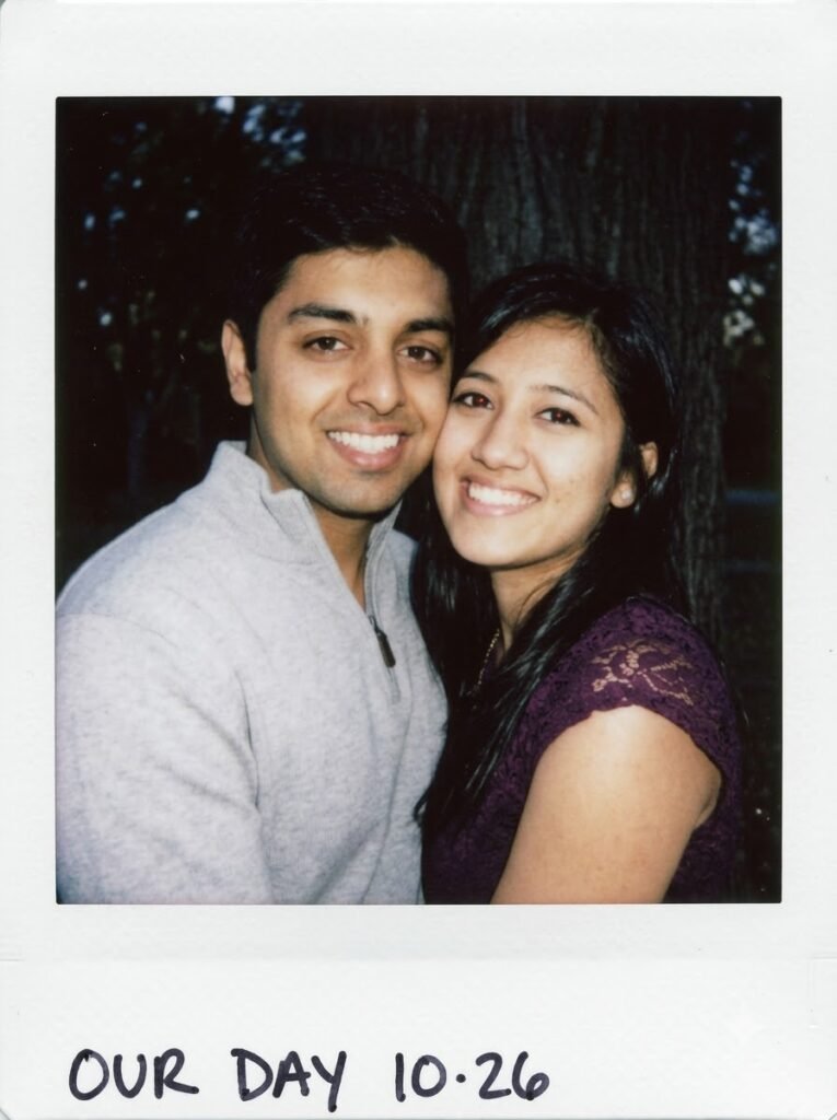 Couple posing cheek to cheek in a warm Polaroid-style portrait