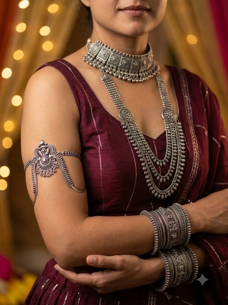 Layered oxidised necklace, armlet and bangles against a maroon chaniya choli
