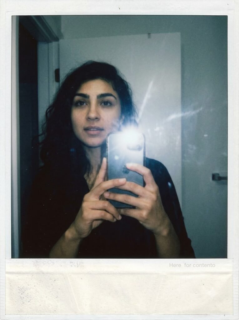 Polaroid-style mirror selfie with direct flash and muted tones