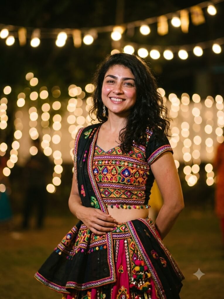 Woman pausing during garba with warm string lights softly blurred behind her